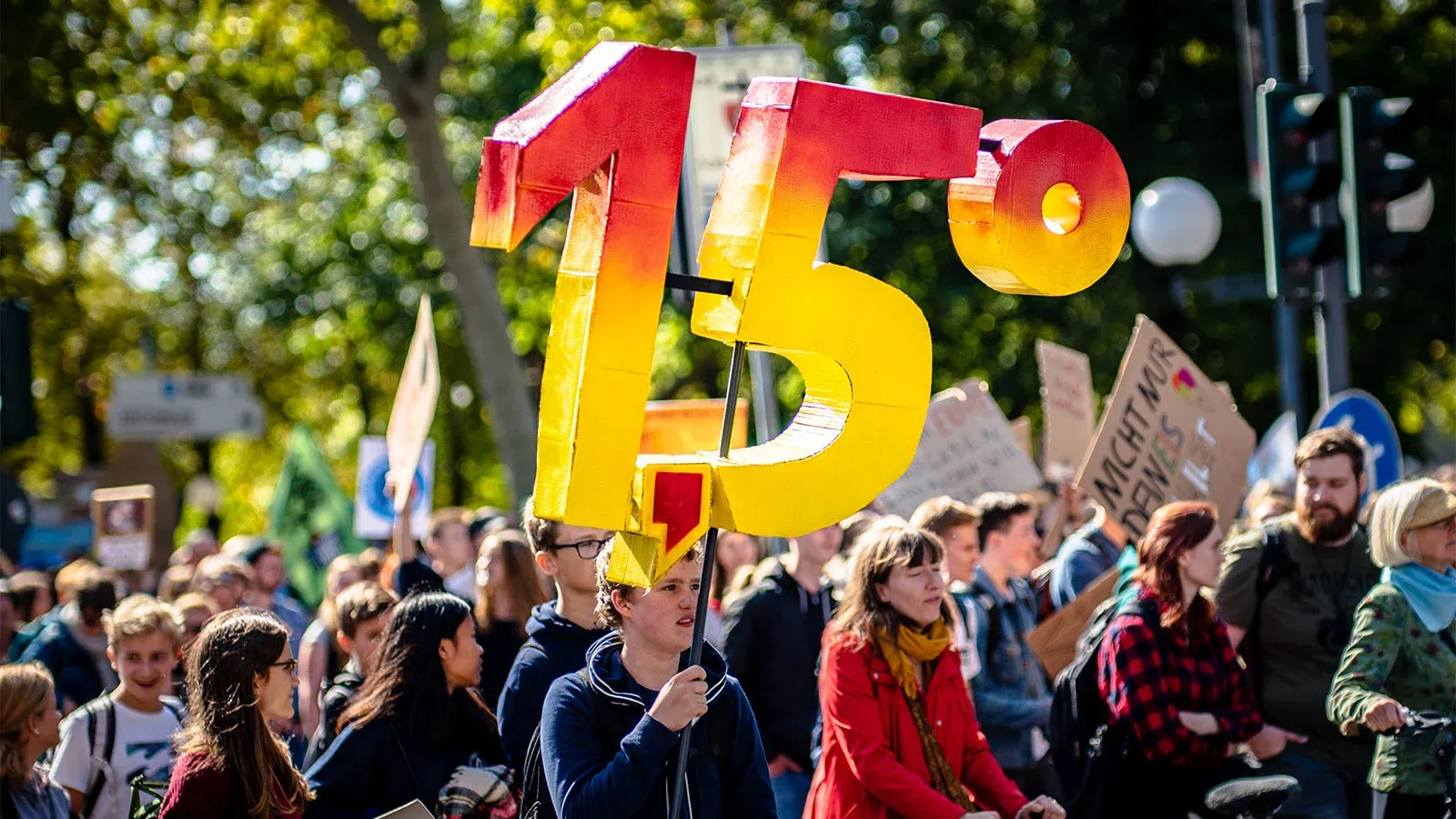 Climate protesters holding a sign about the 1.5 degree limit.